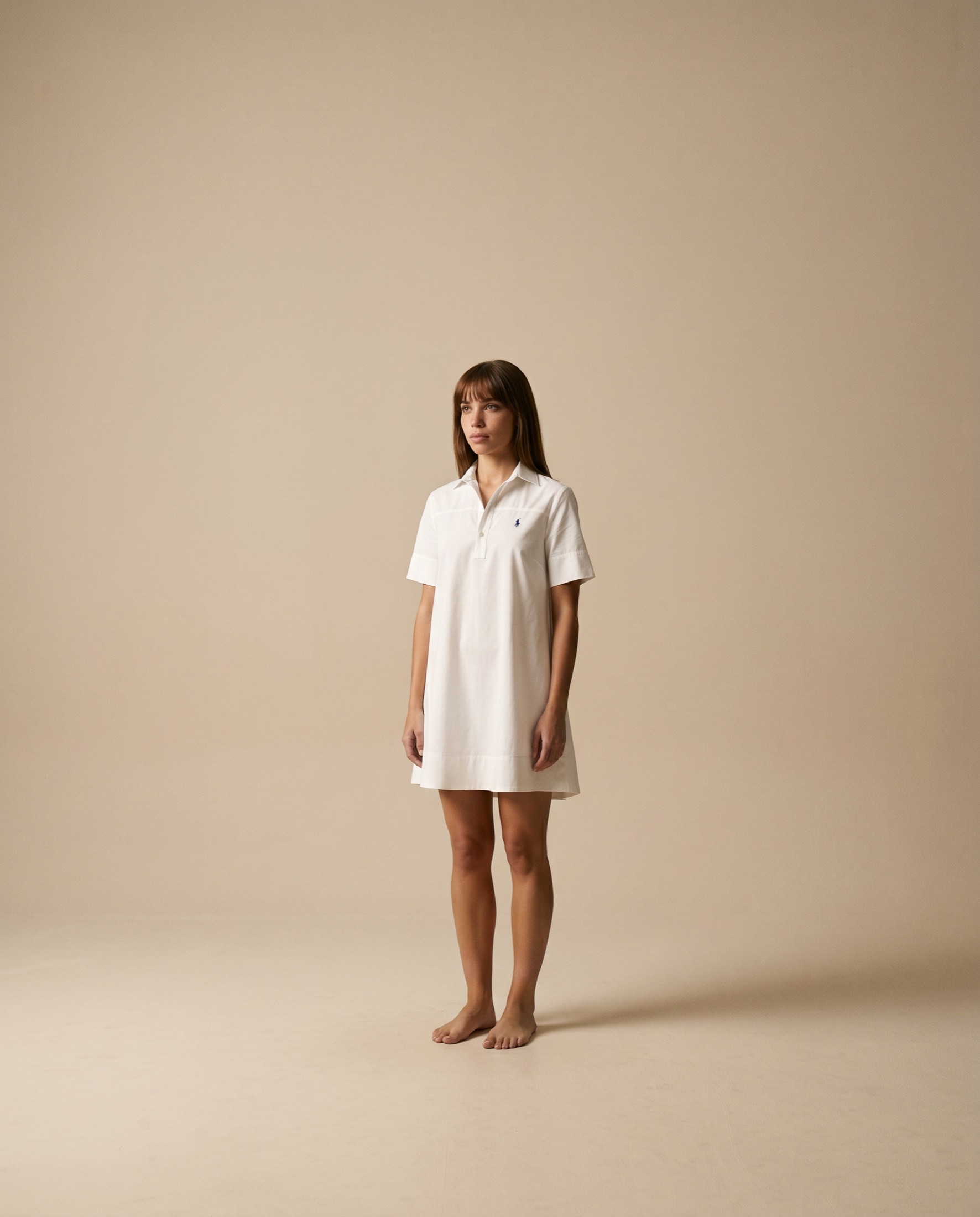 Ralph Lauren lifestyle campaign — white polo dress, front-on studio portrait